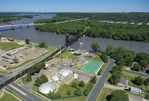 Aerial view of a wastewater treatment plant near a river.