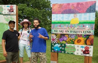 Artists Witt Siasoco, Marlena Myles, and CRICE pose with their signs