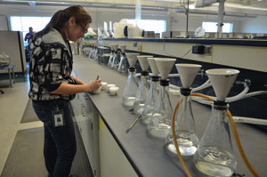 An employee tests a water sample.